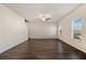 Spacious living room with dark hardwood floors and ceiling fan at 412 Vermeer Ct, Locust Grove, GA 30248