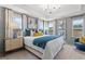 Main bedroom with plush bed, elegant chandelier and large windows at 8214 Tiger Way, Riverdale, GA 30274