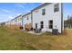 Rear view of the property with a patio, lawn, and wooden privacy fences dividing yards at 8214 Tiger Way, Riverdale, GA 30274