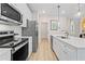 Modern kitchen with stainless steel appliances, white cabinetry, and ample counter space at 8214 Tiger Way, Riverdale, GA 30274