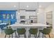 Modern kitchen island featuring stainless steel appliances, pendant lighting, and bar seating at 8214 Tiger Way, Riverdale, GA 30274