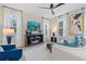 Comfortable living room featuring modern furniture, a ceiling fan, and bright natural light at 8214 Tiger Way, Riverdale, GA 30296