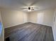 Spacious bedroom with vinyl flooring, ceiling fan, and two doors at 3698 Fairlane Nw Dr, Atlanta, GA 30331