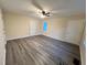 Large bedroom with vinyl flooring, ceiling fan, and two doors at 3698 Fairlane Nw Dr, Atlanta, GA 30331