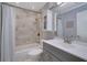 Updated bathroom with marble tile, shower/tub combo, and modern vanity at 5400 Roswell Rd # P2, Atlanta, GA 30342