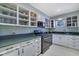 Modern kitchen with white cabinets, green countertops, and stainless steel appliances at 5400 Roswell Rd # P2, Atlanta, GA 30342