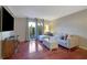 Living room with hardwood floors, sectional sofa, and patio doors at 5400 Roswell Rd # P2, Atlanta, GA 30342