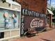 Grant Park Coffee shop storefront with Coca-Cola mural and whimsical window display at 628 Robinson Se Ave # B, Atlanta, GA 30312