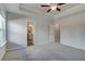 Bright bedroom featuring a ceiling fan, neutral paint, and doorways leading to closet and bathroom at 8210 Tiger Way, Riverdale, GA 30296