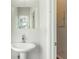 Simple bathroom with pedestal sink and built-in storage at 2605 Poplar Ln, Cumming, GA 30041