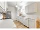 Bright kitchen featuring white cabinets and stainless steel appliances at 2605 Poplar Ln, Cumming, GA 30041
