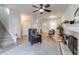 Open living room with hardwood floors, fireplace, and access to stairs at 2605 Poplar Ln, Cumming, GA 30041