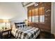 Cozy bedroom with exposed brick wall and large window at 3235 Roswell Ne Rd # 718, Atlanta, GA 30305