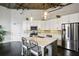Modern kitchen with white cabinets, stainless steel appliances and an island at 3235 Roswell Ne Rd # 718, Atlanta, GA 30305