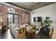 Spacious living room with exposed brick, hardwood floors, and comfortable seating at 3235 Roswell Ne Rd # 718, Atlanta, GA 30305