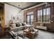 Open living area with exposed brick wall, large windows and comfortable seating at 3235 Roswell Ne Rd # 718, Atlanta, GA 30305