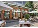 Outdoor patio seating area with tables, chairs, and umbrellas at Le Bilboquet at 3235 Roswell Ne Rd # 718, Atlanta, GA 30305