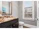 Elegant powder room featuring a marble countertop and modern fixtures at 327 Brownstones Ne Cir, Atlanta, GA 30312