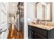 Convenient powder room with dark vanity and stone countertop at 327 Brownstones Ne Cir, Atlanta, GA 30312