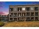 Evening view of townhomes with city skyline in background at 327 Brownstones Ne Cir, Atlanta, GA 30312