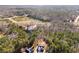 Aerial view of property near Jackson Lake, wooded area, and homes at 55 Hastings Ln, Covington, GA 30014