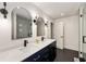 Modern bathroom with dark blue double vanity and arched mirrors at 705 Old Post Rd, Atlanta, GA 30328