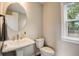 Small bathroom with pedestal sink and window at 1023 Brandsford Nw St, Atlanta, GA 30318