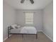 Simple bedroom with twin bed, neutral walls, and window coverings at 8791 Daerwater Dr, Winston, GA 30187