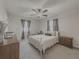 Bright bedroom with a queen bed, ceiling fan, and neutral decor at 8791 Daerwater Dr, Winston, GA 30187