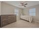 Cozy bedroom with twin bed, dresser, and ceiling fan at 8791 Daerwater Dr, Winston, GA 30187