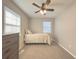 Well-lit bedroom with twin bed, dresser, and ceiling fan at 8791 Daerwater Dr, Winston, GA 30187
