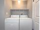 Bright laundry room with washer and dryer at 8791 Daerwater Dr, Winston, GA 30187