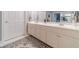 Double vanity bathroom with white cabinets and a patterned rug at 2040 Hickory Station Cir, Snellville, GA 30078