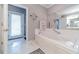 Bathroom featuring a jetted tub, and access to backyard at 2040 Hickory Station Cir, Snellville, GA 30078