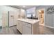 Kitchen with island, white cabinets and hardwood floors at 2040 Hickory Station Cir, Snellville, GA 30078