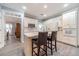 Kitchen with island, white cabinets, and hardwood floors at 2040 Hickory Station Cir, Snellville, GA 30078
