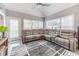Sunroom features grey sectional and ceiling fan at 2040 Hickory Station Cir, Snellville, GA 30078
