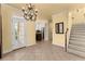 Elegant dining room with tile floors, chandelier, and kitchen access at 2815 Windrush Dr, Buford, GA 30518