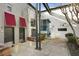 Contemporary condo exterior with red awnings, grey doors, and concrete courtyard at 195 Arizona Ne Ave # 158, Atlanta, GA 30307