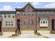 Brick front exterior of charming townhome with two-car garage at 279 Commons Ave, Woodstock, GA 30188