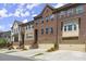 Brick townhouses with attached garages and landscaping at 279 Commons Ave, Woodstock, GA 30188