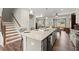 Modern kitchen island, granite countertops, and hardwood floors at 279 Commons Ave, Woodstock, GA 30188