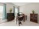 Home office with a wooden desk and vintage storage cabinet at 279 Commons Ave, Woodstock, GA 30188