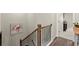 Upper hallway with staircase, hardwood floors, and access to bedrooms at 279 Commons Ave, Woodstock, GA 30188