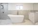 Elegant bathroom featuring a freestanding bathtub and gray tile at 2982 Cruse Rd, Lawrenceville, GA 30044