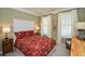 Charming bedroom with red bedding and white headboard at 314 Pepperwood Way, Canton, GA 30114