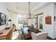 Sunlit dining room featuring a rustic farm table and chandelier at 314 Pepperwood Way, Canton, GA 30114