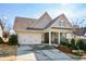 House exterior showcasing a two-car garage and neat landscaping at 314 Pepperwood Way, Canton, GA 30114