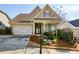 Tan house with a two-car garage and manicured landscaping at 314 Pepperwood Way, Canton, GA 30114