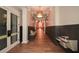 Hallway with hardwood floors, a built-in bench, and access to a kitchen at 314 Pepperwood Way, Canton, GA 30114